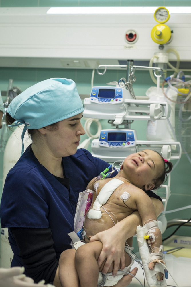 Amelie caring for a baby in Tobruk, Libya